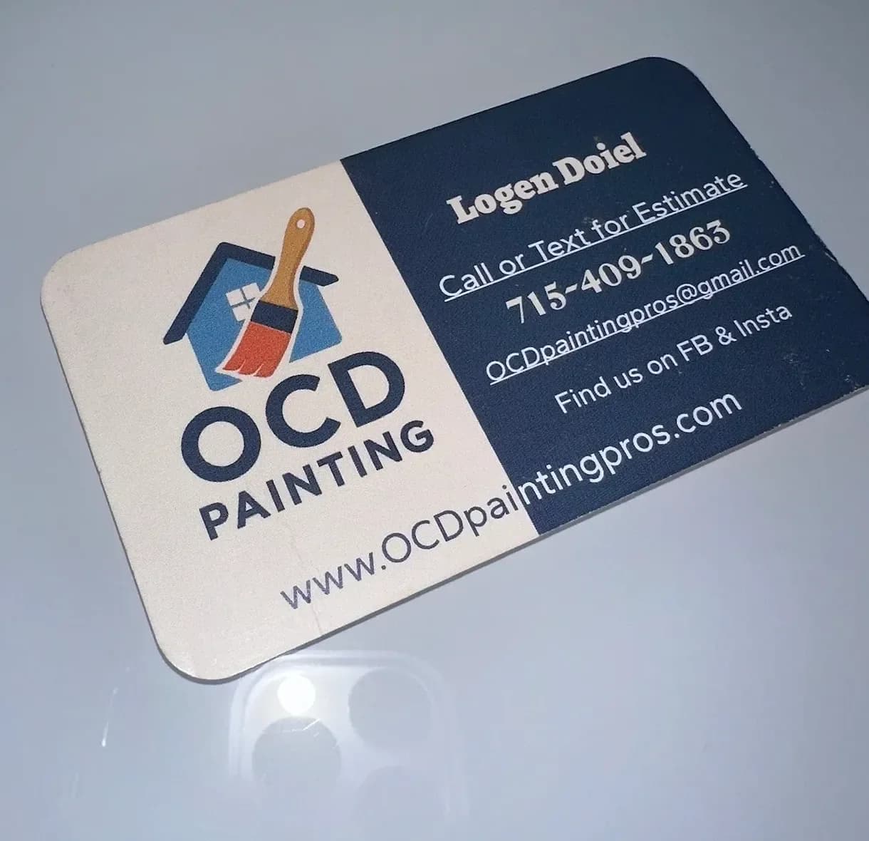 Logen Doiel's old OCD Painting business card with the house-and-paintbrush logo